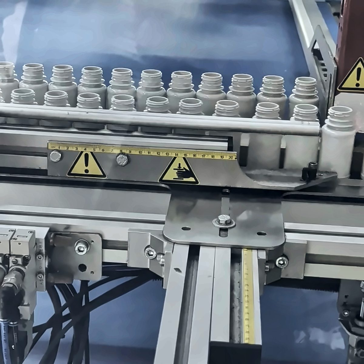 A row of white bottles at the packing machine